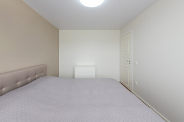 Minimalism Children, Young Adult Living Room Interior. Chest of Drawers. Gray Blanket on the Bed. LED Light. White Door