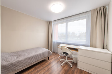 Minimalism Children, Young Adult Living Room Interior. Gray Blanket on the Bed. Windows and Curtains. LED Light, Table in Background