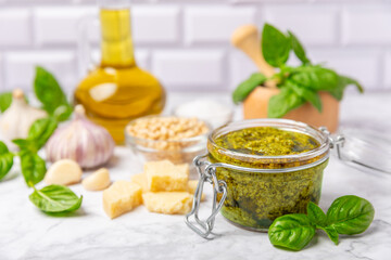 Pesto. Italian basil pesto sauce on a textured wooden background. Ingredient for pesto sauce: fresh...