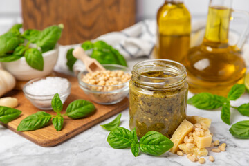 Pesto. Italian basil pesto sauce on a textured wooden background. Ingredient for pesto sauce: fresh...