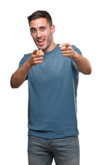 Fototapeta premium Handsome young casual man pointing fingers to camera with happy and funny face. Good energy and vibes.