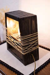 Edison table lamp on the table. A stylish wooden lamp in a loft style. Night lamp light bulb.