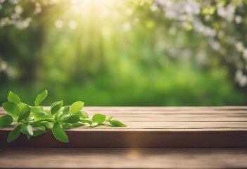 Spring beautiful background with green juicy young foliage and empty wooden table in nature outdoor