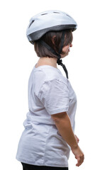 Young adult cyclist woman with down syndrome wearing safety helmet over isolated background looking to side, relax profile pose with natural face with confident smile.