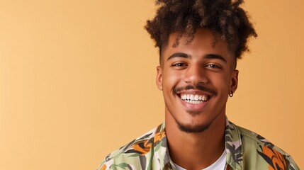 A man with a beard and a smile is wearing a green shirt. He is smiling and looking at the camera