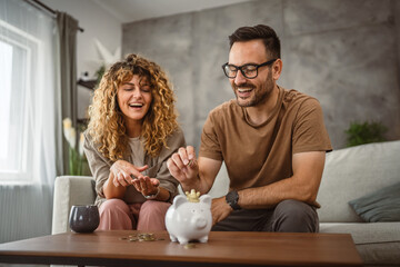 Adult couple wife and husband save money together in the piggy bank