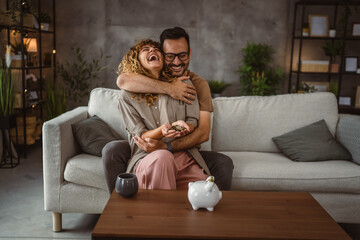 Obraz premium Adult couple wife and husband save money together in the piggy bank