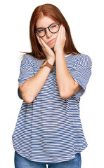 Young read head woman wearing casual clothes and glasses tired hands covering face, depression and sadness, upset and irritated for problem