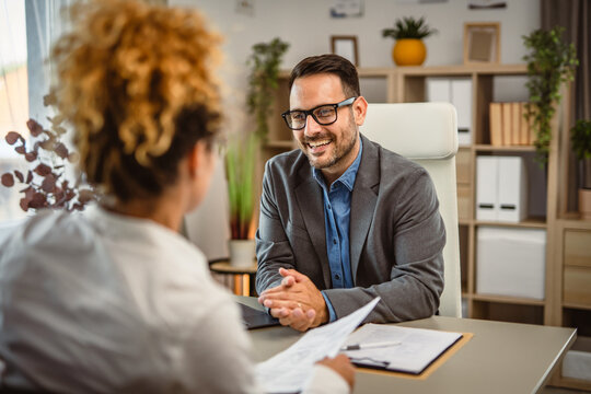 Woman on interview for a job with her biography CV at office