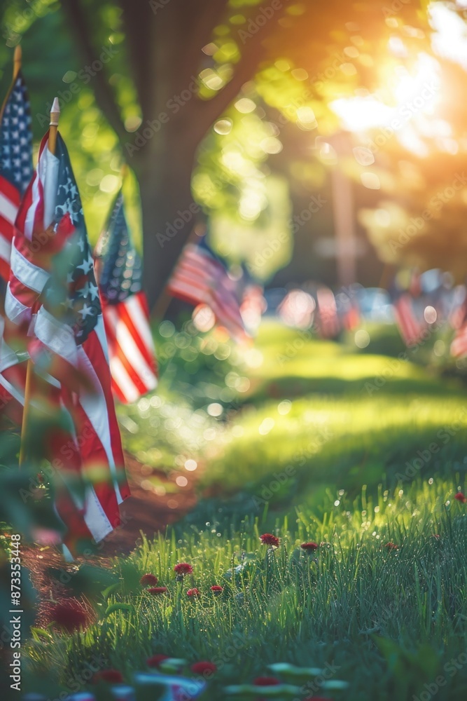 Poster a row of american flags are displayed in a field. the flags are in various sizes and are arranged in