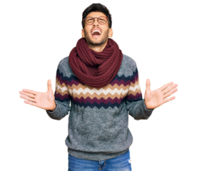 Young handsome man wearing casual winter sweater celebrating mad and crazy for success with arms raised and closed eyes screaming excited. winner concept