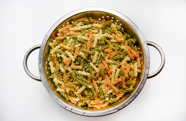 Multicolored pasta in a colander. Boiled pasta.