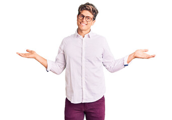 Young handsome man wearing business clothes and glasses smiling showing both hands open palms, presenting and advertising comparison and balance