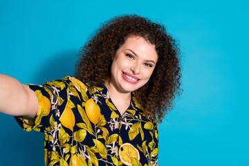 Photo of cheerful pretty lady dressed print shirt tacking selfie empty space isolated blue color background