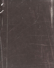 Dark maroon textured surface with scratches and marks, indicative of wear and weathering.