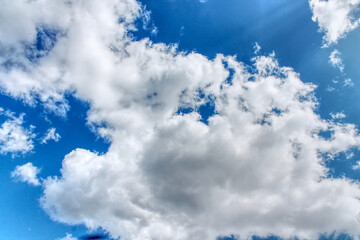 Clouds in a blue sky ,white fluffy clouds on a back ground of blue sky on a summers day Knottingley West Yorkshire In UK a HDR image
