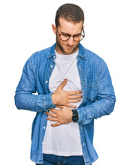 Young caucasian man wearing casual clothes with hand on stomach because indigestion, painful...