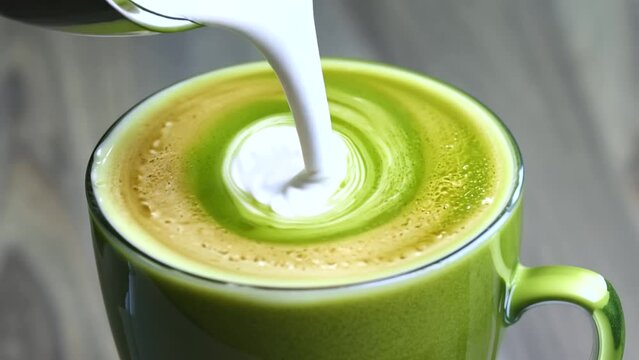 creamy coconut matcha latte with a swirl of coconut cream, served in a glass mug