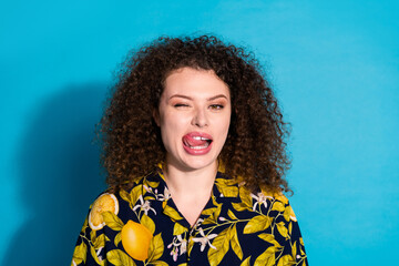Photo of cheerful pretty lady dressed print shirt winking eye licking lips empty space isolated...