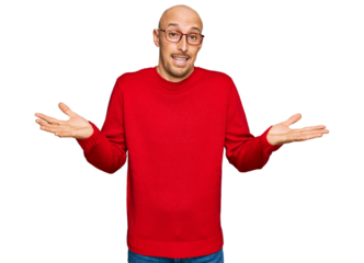 Bald man with beard wearing casual clothes and glasses clueless and confused expression with arms and hands raised. doubt concept.