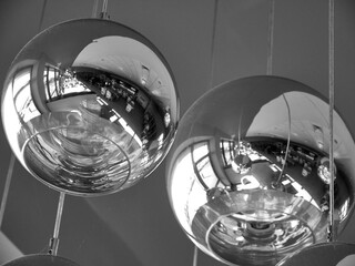 Modern chandelier background, round lamps over ceiling pattern, black and white monochrome photo