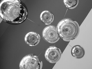 Modern chandelier background, round lamps over ceiling pattern, black and white monochrome photo
