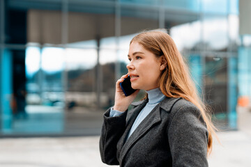 Young Woman Talking on Cell Phone in City