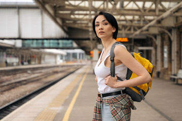 Woman Standing on Train Platform at  Modern Train Station