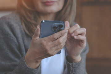 Woman Using Smartphone Indoors During Daytime