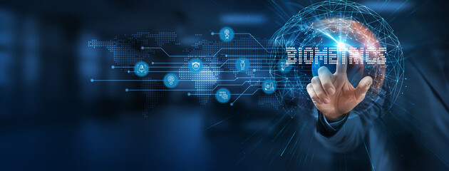 Implementing biometrics provides a smart solution to secure authentication. Businessman points at virtual biometrics network connecting service with graphical icons in modern, technological industry.