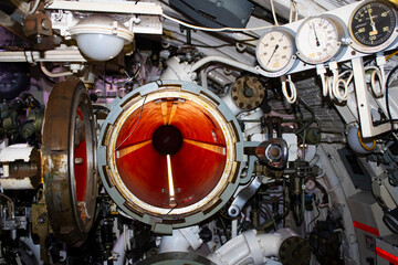 Explore the intricate world of an Australian submarine in Sydney, NSW. This captivating 
photo captures the essence of a small control room adorned with a multitude of controls, meters, and gauges.