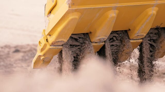Slow motion excavator bucket dirt dump