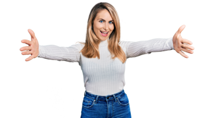 Young blonde woman wearing casual clothes looking at the camera smiling with open arms for hug. cheerful expression embracing happiness.