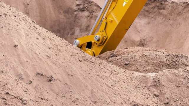 Slow motion excavator bucket shoveling dirt