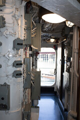 Discover the control hub within an Australian naval warship. A corridor of precision and power, navigating Sydney's seas with a myriad of controls, leading to the door of the great expanse beyond