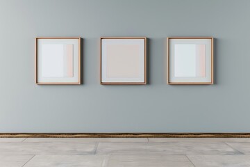 A minimalist mockup template showing three framed artworks on a light gray wall, spaced evenly. The environment is simple, focusing on the artwork with no distractions.