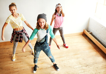 Fototapeta premium Dancing, group or top view of kids with friends, girl or rhythm for creative performance or studio rehearsal. Teamwork, choreography class or happy children in cool crew for learning practice routine