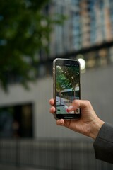 smartphone in female hands. The girl takes pictures on her phone. Shooting video with a phone camera. Photo, video, filming © Maslov