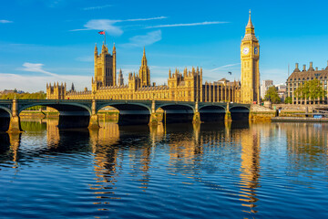Houses of parliament with Big Ben tower and Westminster bridge reflected in Thames river, London, UK
