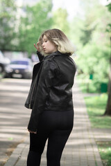 Fototapeta premium Portrait of a beautiful young beautiful girl in an urban environment.