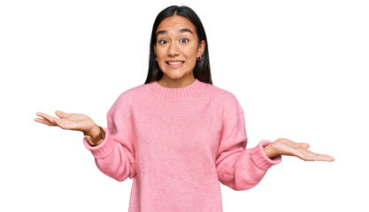 Young asian woman wearing casual winter sweater smiling cheerful with open arms as friendly welcome, positive and confident greetings