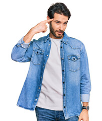 Young hispanic man wearing casual clothes smiling pointing to head with one finger, great idea or thought, good memory