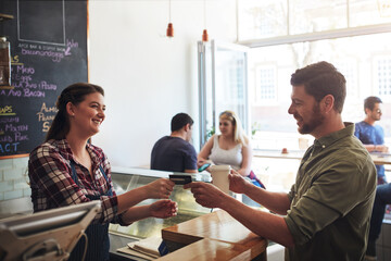 Woman, pay and man in cafe with gift card, service and transaction in coffee shop. Barista, female...