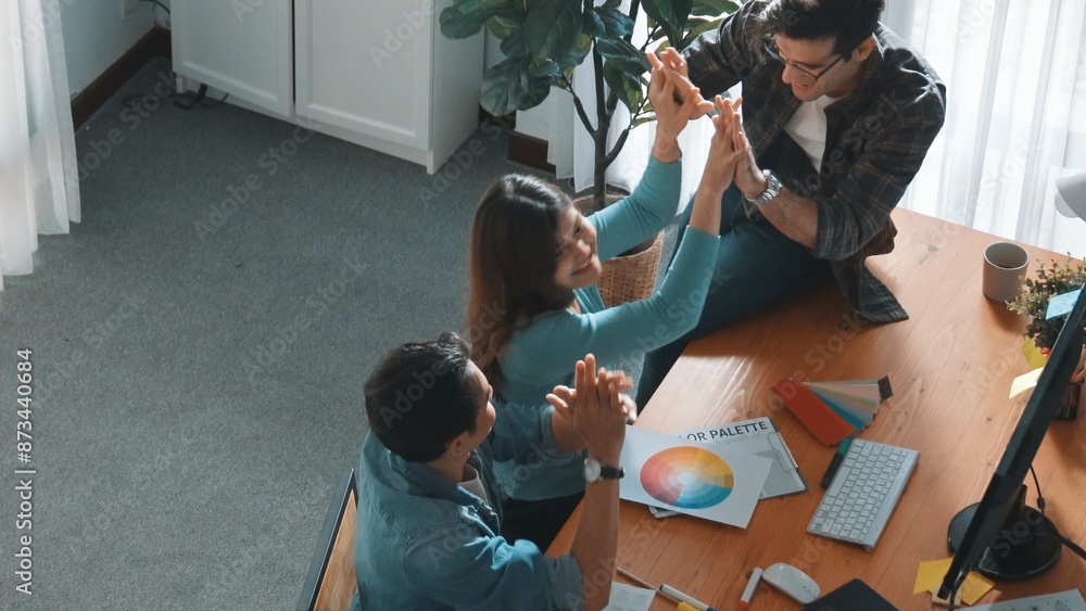 Poster top view of professional business team hands looking at color palette at table while giving high fiv