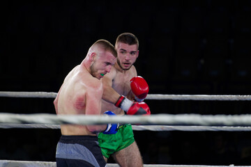 Fierce boxing match showcases athletes' power and skill.
