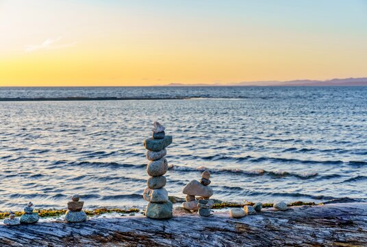 Stacking stones at beach in Parksville, BC, Canada 