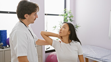 A female patient receives careful neck examination by a male physiotherapist in a bright clinic room.