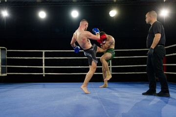 Kickboxing rivals unleash powerful leg strikes in a thrilling match.