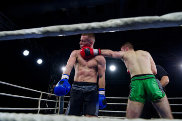 Fierce boxing match showcases athletes' power and skill.