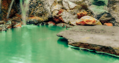 Fototapeta premium A Blurred Foreground Rock Shelf for a Product Display, Leading to a Depiction of a Contaminated waterfall with Toxic Rocks and Infected Moss Ecology.